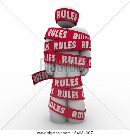Rules word on red tape wrapped around a man or person to illustrate following regulations, guidance or laws to be in compliance 