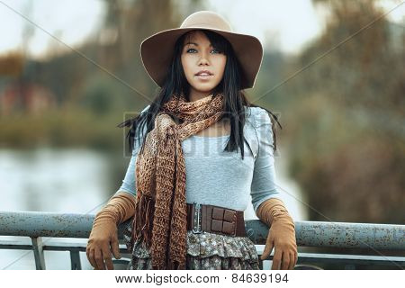 Portrait Of  Girl In A Hat And Scarf On The Bridge
