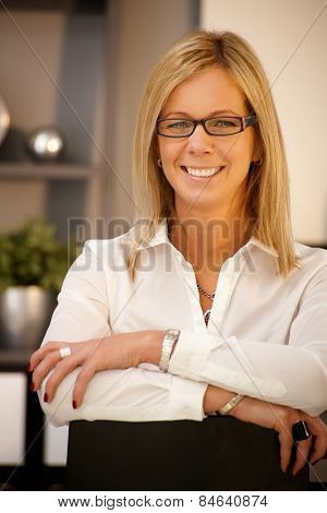 Closeup portrait of happy blonde businesswoman smiling, looking at camera.