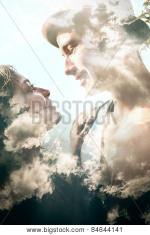 Double exposure portrait of a couple combined with photograph of clouds