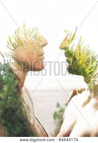 Double exposure portrait of a couple combined with photograph of greenery