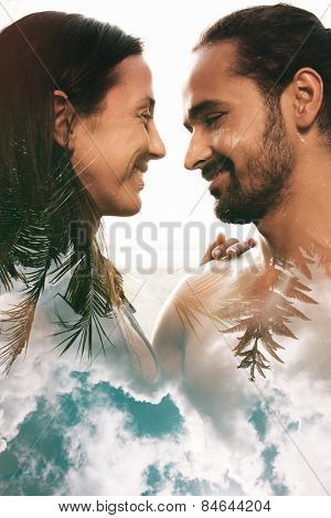 Double exposure portrait of couple combined with photograph of trees and clouds