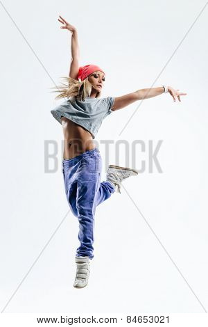young beautiful dancer posing on a studio background