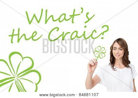 Smiling businesswoman holding marker against shamrock