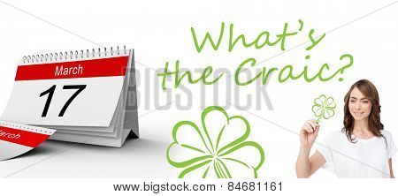 Smiling businesswoman holding marker against shamrock
