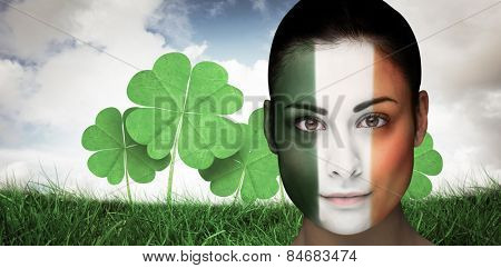 Brunette in irish face paint against blue sky with white clouds
