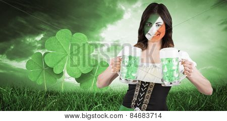 Irish girl with beer against orange and blue sky with clouds