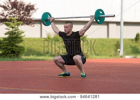 Young Man Doing A Overhead Squat Exercise Outdoor