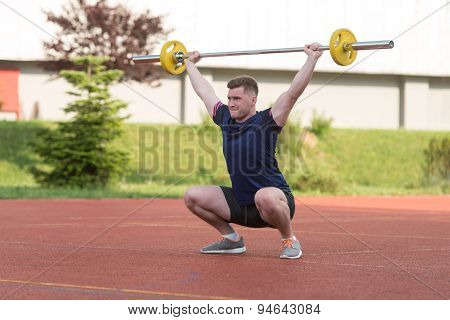 Young Man Doing A Overhead Squat Exercise Outdoor