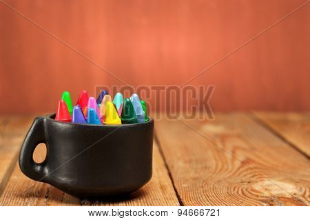 Crayons In A Mug On A Wooden Table