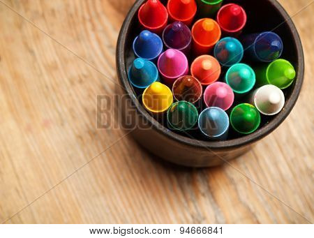 Crayons In A Mug On A Wooden Table