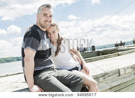 Father daughter sit sea