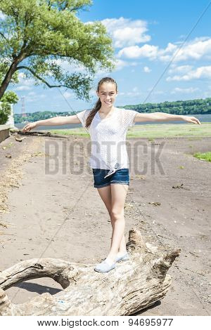 Portrtait of a happy girl at the beach enjoying the life