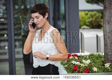 Businesswoman talking on mobile phone in office premises
