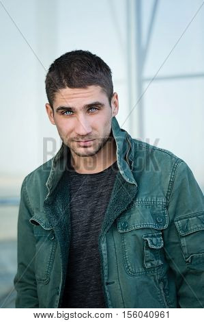 Portrait of a man with pale blue eyes. Men beauty. Street fashion. Eyes like a Husky. Piercing eyes.