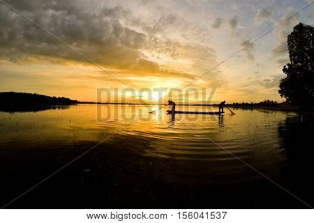 Fishermen out fishing with nets in the morning sunrise.