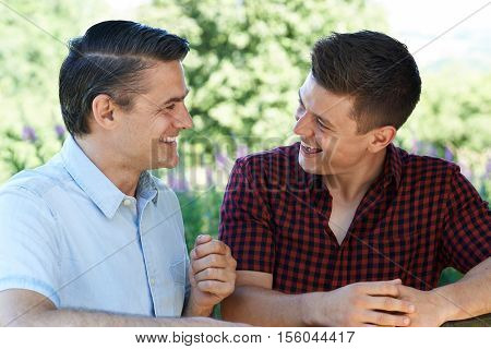 Mature Father Talking To Adult Son Outdoors
