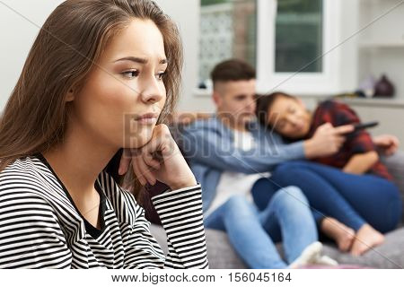 Teenage Girl Jealous Of Young Couple At Home