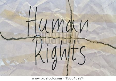 Text Human Rights written on torn white paper
