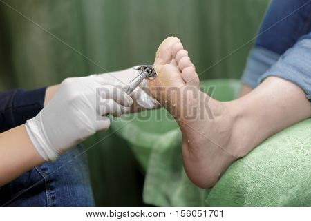 Pedicure  procedure in the beauty salon.  emover calluses on the feet. Foot care.