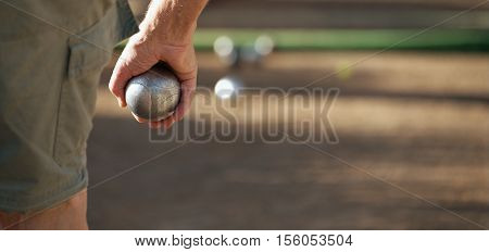 Senior playing petanque fun and relaxing game