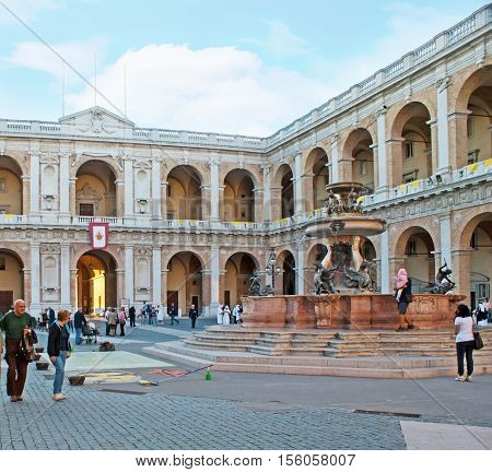 LORETO ITALY - OCTOBER 6 2012: The The Apostolic Palace and old fountain with mythic creatures are the notable landmarks of the city located in Square of Madonna on October 6 in Loreto.