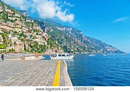 The pleasure boats are very popular on Amalfi Coast it's the best choice to enjoy the views nature Mediterranean architecture and relax riding on the calm waves Positano Italy.