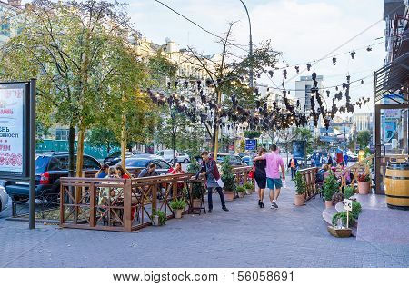 KIEV UKRAINE - SEPTEMBER 18 2016: The outdoor terrace of the Georgian restaurant decorated with the bunches of grapes drying over the street on September 18 in Kiev.