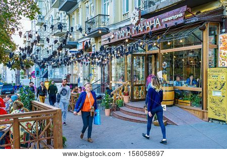 KIEV UKRAINE - SEPTEMBER 18 2016: The Georgian restaurant offers the tasty cuisine and wines and attracts clients with the bunches of grapes drying over the street on September 18 in Kiev.