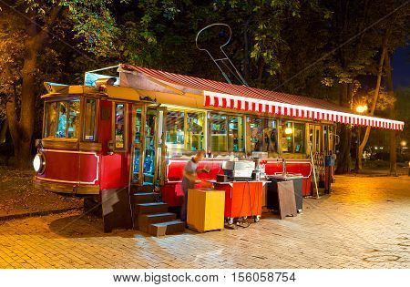 KIEV UKRAINE - SEPTEMBER 11 2016: The interesting outddor cafe in old tram in Taras Shevchenko park offers tea coffee and refreshing beverages on September 11 in Kiev.