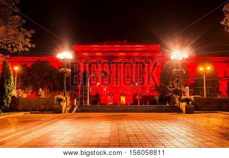 The red building of National University of Taras Shevchenko in bright red illumination Kiev Ukraine.