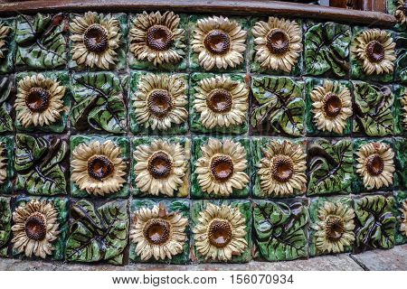 Comillas Spain - August 24 2016: La Villa Quijano popularly known as El Capricho is a modernist building in Comillas. Designed by Antoni Gaudi Detail ceramic floral motif with sunflowers
