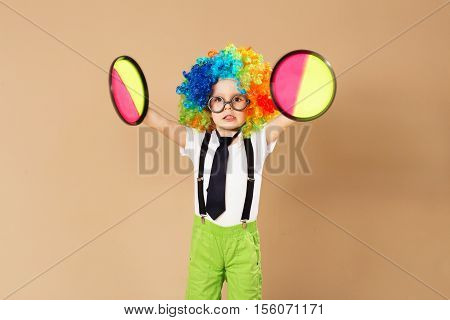 Kid In Clown Wig And Eyeglasses Playing Catch Ball Game