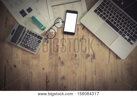 Office Desk Mockup: Laptop, Smart Phone, And Cup Of Coffee And Notebook With Business Financial Grap