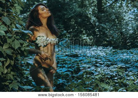 young girl in underwear leaf with closed eyes in the forest outdoors