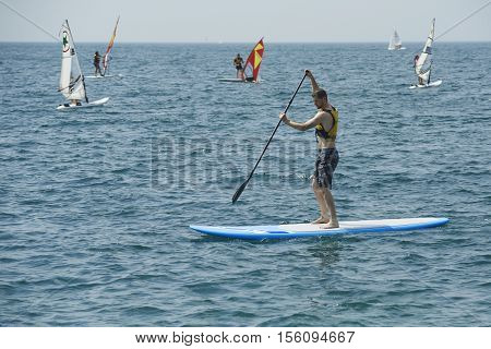Torbole - Nago, Lago di Garda (Lago Benaco), Italy - August 11, 2015: A windsurfing on Lake Garda in Torbole resort.