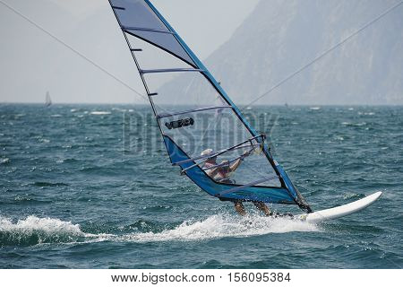 Torbole - Nago, Lago di Garda (Lago Benaco), Italy - August 11, 2015: A windsurfing on Lake Garda in Torbole resort.