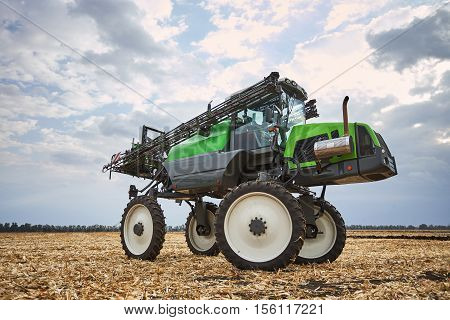 Farming techniques, high tractor irrigation fields, agricultural industry, tractor on the background of sky, a tractor for the care of plants