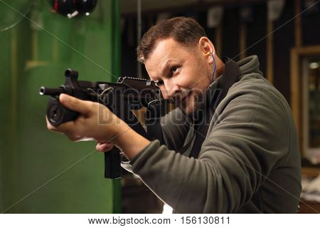Shooting a gun at shooting range .