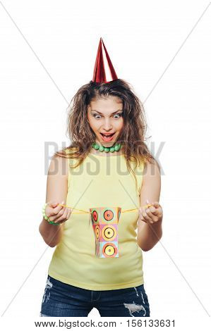 Girl in the yellow shirt and red cap opens the gift bag and is surprised content