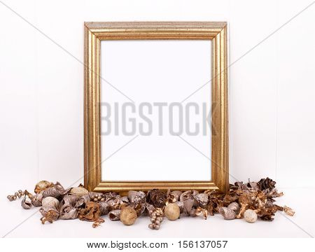 Christmas styled mockup portrait frame with gold potpourri in front of the frame