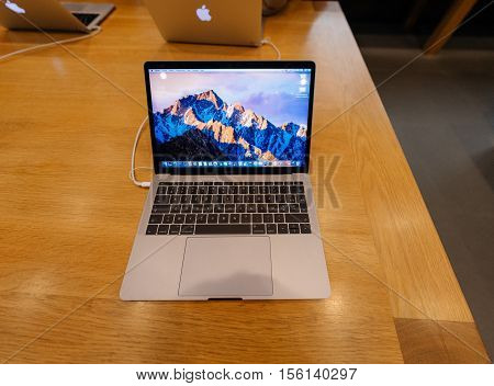 PARIS FRANCE - NOV 10 2016: New latest MacBook Pro Retina with on wooden table. The fourth generation MacBook Pro was revealed on October 27 2016. Phil Schiller described it as the 