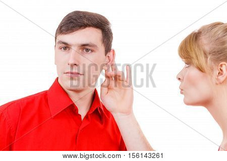 Woman telling man some secrets couple talking gossiping. Excited emotional girl whispering to boyfriend ear