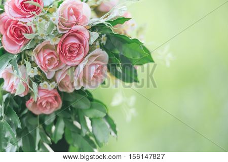 Pink fabric rose flowers bouque vintage on green background with copy space