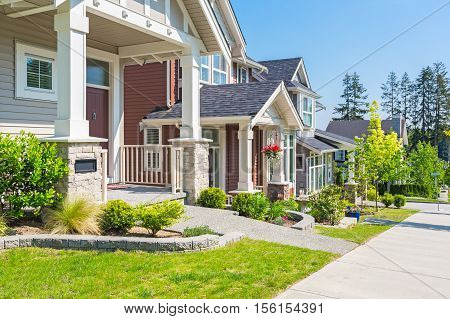 Custom built house in the nice neighbourhood on a sunny day.