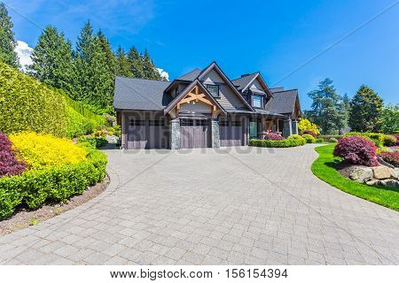 Custom built house in the nice neighbourhood on a sunny day.