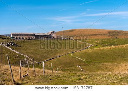 Typical old farm house (malga) for the breeding of cows with a small church. Plateau of Lessinia and Italian Alps Verona Veneto Italy