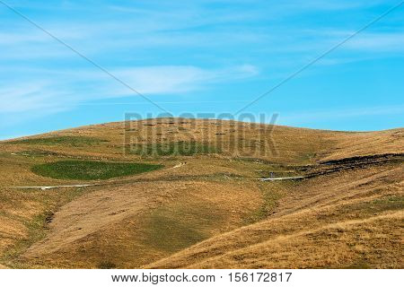 Green and brown pastures in autumn. Plateau of Lessinia Regional Natural Park of Lessinia Veneto Verona Italy