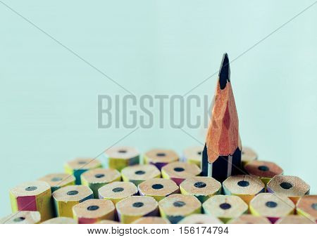 One sharpened pencil standing out from the other new pencil.