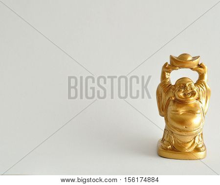 Figurine of a laughing and cheerful golden Buddha